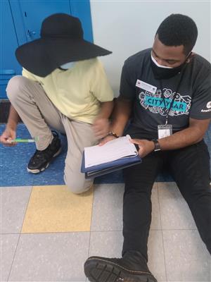 City Year Member and student reading